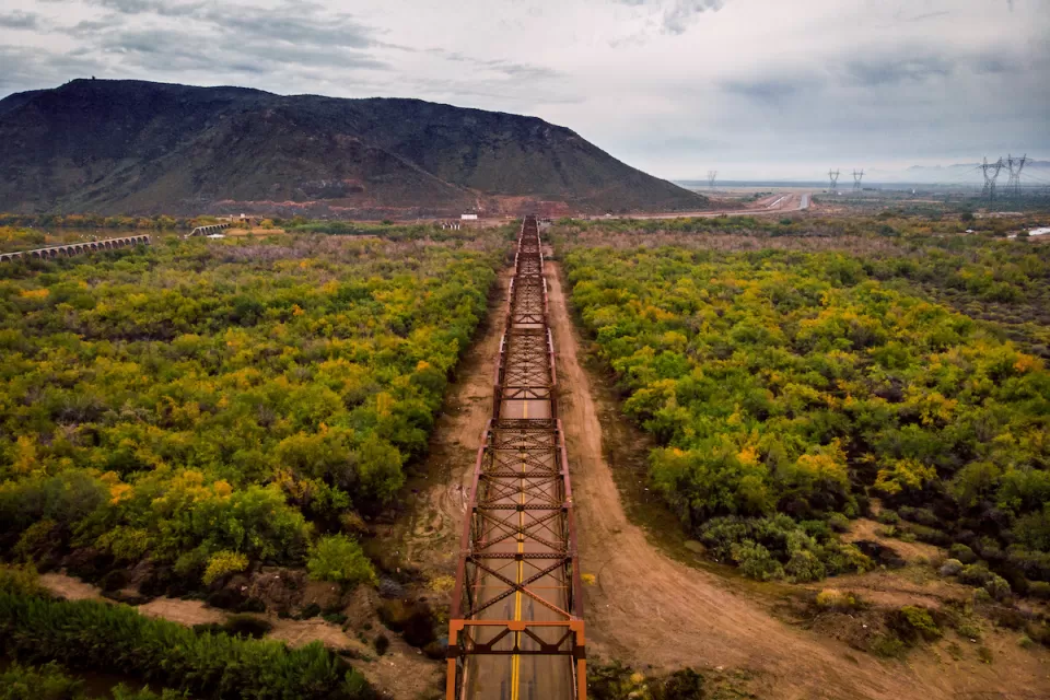 Aerial view of Gillespie Bridge with metal framing and black rock mesa in background in Gillespie, Arizona.